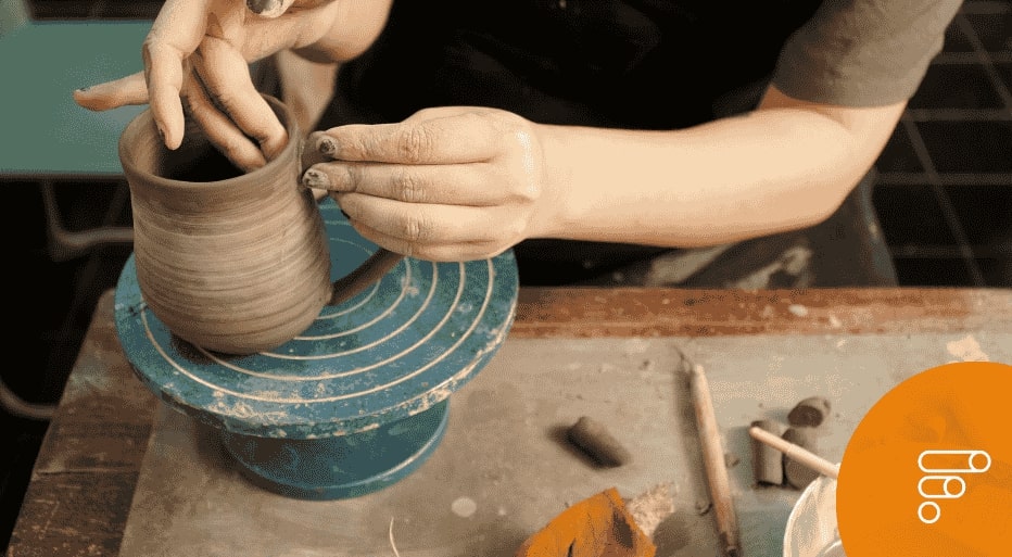 Mani al lavoro di un vaso su un tornio, simbolo di un'impresa artigiana che partecipa al bando Impresa Possibile